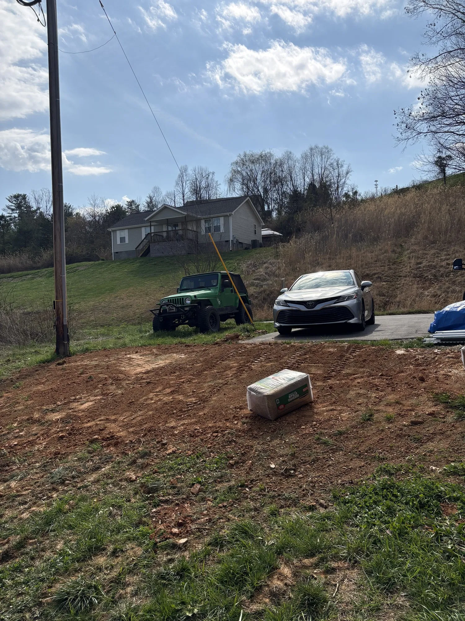 Residential yard with fill dirt spread and graded after delivery